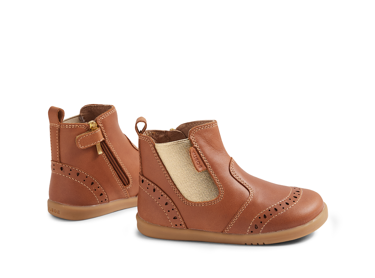 Pair of brown children's boots on a white background