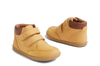 Pair of yellow children's shoes with brown soles on a white background